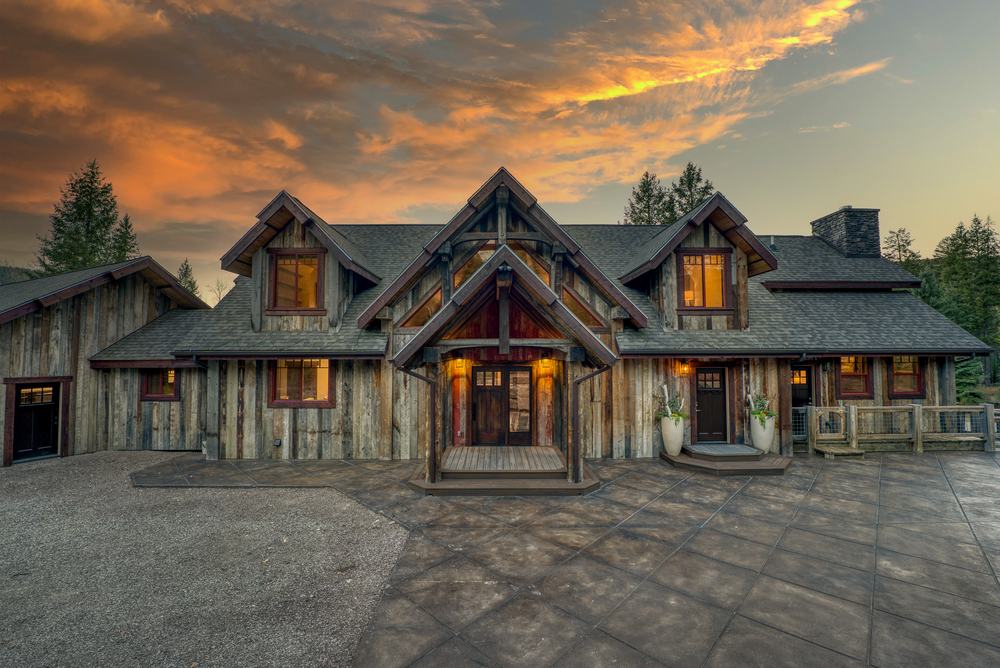 Front entrance of the Main House at dusk, with timber gables and warm lit windows