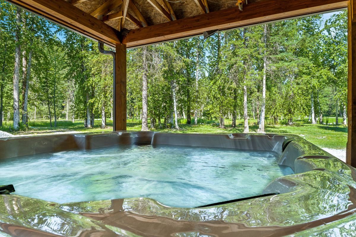 Covered private hot tub facing the trees