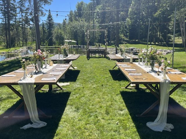 Long reception tables set on the lawn under string lights